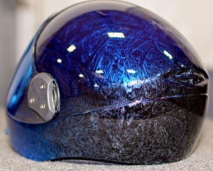 "My personal helmet is a Cookie G3 and is pretty plain at the moment (see above)," says Marissa. "I have a 4-stage paint job on it. It starts out bright blue in the front with some metal flake, transitions to a blue/black marbleized texture on the top, and then transitions again to a black/silver marbleized texture in the back. I bought this used from a tunnel instructor, very beat up and damaged, but I did it to show exactly how significant the transformation can be."